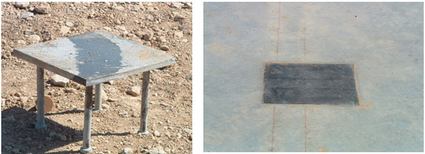 Photograph indicating procedure for erecting steel column using four pre-attached anchor rods attached to the column, and that assembly is embedded into the concrete footing.