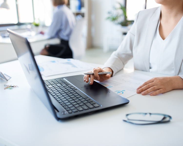 A woman working at a laptop