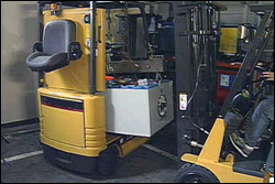 Figure 5. Battery hoisted from forklift compartment with lifting beam.