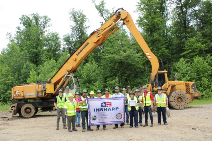 North Vernon River Metals employees standing with their SHARP flag