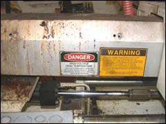 Figure 7. A guard equipped with safety signs covers the barrel of the injection unit.