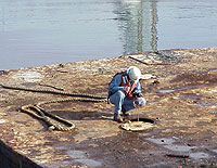 Figure 3: Shipyard Competent Person testing a confined space before entry
