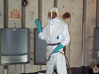 Figure 6: Worker with disposable suit, gloves and face protection