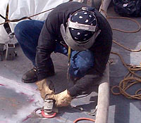 Figure 19: Worker grinding with leather gloves