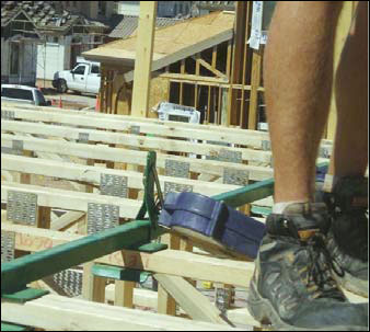 Figure 17 - A retractable lifeline attached to a floor truss anchor. For problems with accessibility in using figures and illustrations, please contact the DOC at 202-693-2020.