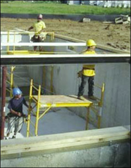 Figure 18 - Workers installing a steel beam from a mobile scaffold. For problems with accessibility in using figures and illustrations, please contact the DOC at 202-693-2020.