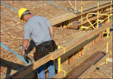 Figure 8 - A worker sheathing a roof from a bracket scaffold. For problems with accessibility in using figures and illustrations, please contact the DOC at 202-693-2020.