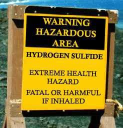 A sign warning workers of hydrogen sulfide hazards.
