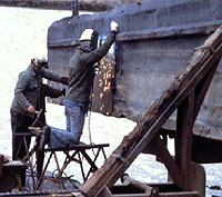 Figure 1: Workers on horse scaffold burning on hull near water not protected with lifejackets (PFDs)