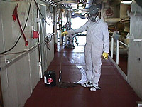 Figure 7: Worker using solvent to degrease deck