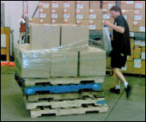 Figure 44. When manually wrapping pallets, elevate them to avoid awkward positions.