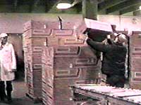 Image of worker stacking boxes on pallet