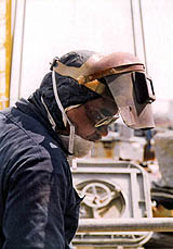 Figure 6: Worker with welding hood and safety glasses.