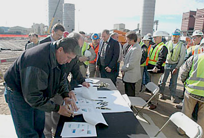 Representatives from the construction trade who are building Weston 4 lined up to sign off on the official OSHA Partnership Agreement. The agreement signifies the strong concern for worker safety and emphasizes the collaborative effort at resolving any safety issues that may arise. The agreement was signed on November 2, 2005.
