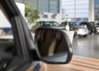 Close up of car side mirror in a dealership showroom