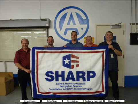 Steve Kovens, John Stup (Maryland Consultation), Dennis Cole, Anthony Jagielski (Maryland Consultation) and Dave Cramer displaying the company’s SHARP flag